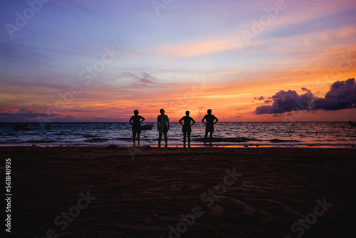 Wonderful sunset watched by four girls travelers in their vacations in Thailand