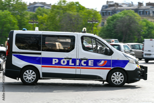 A police truck drives on the road through the city. French national police in action.