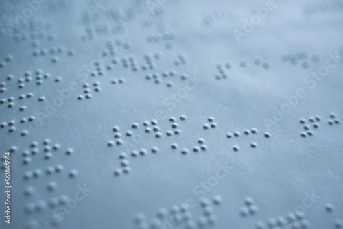 tactile braille type on white page of book for blind people - macro photography
