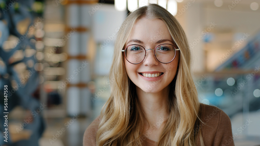 Head shot happy portrait caucasian girl in glasses young woman satisfied with ophthalmology services millennial blonde with healthy white toothy smile looking at camera confident model posing indoors - obrazy, fototapety, plakaty 