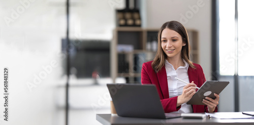 Fotografi Business woman using calculator for do math finance on wooden desk in office and