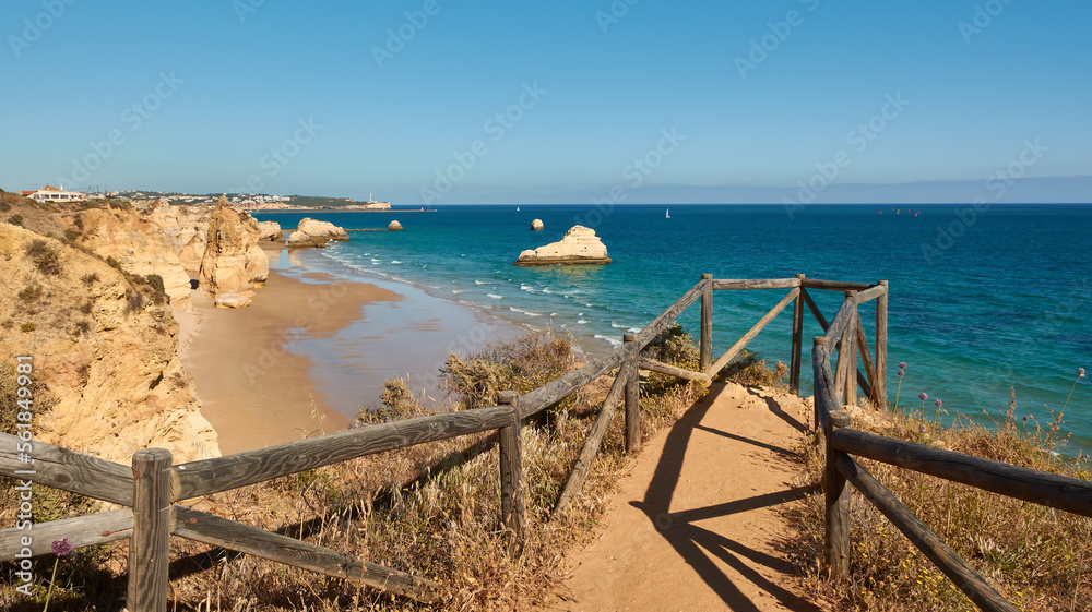 Amazing view of the Praia dos Tres Castelos from the viewpoint with wooden railing. Portimão, Portugal Amazing view of the Praia dos Tres Castelos from the viewpoint with wooden railing. Portimão, Portugal
