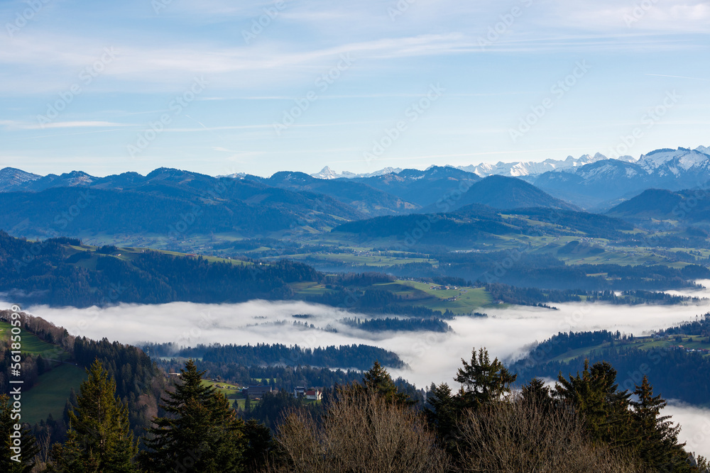 Austrian mountains landscape with fog, blue sky