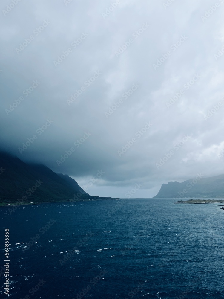 Fjords coastline, ocean bay coastline, cloudy foggy sky