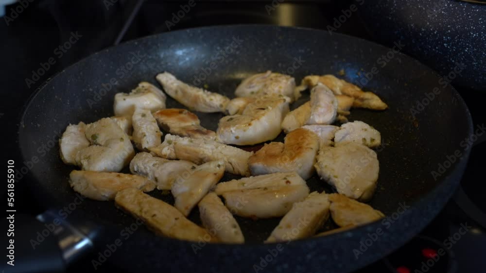 Fried chicken, stir-fried spicy chicken breast. The chicken looks Spicy fried and delicious. Man shaking the pan Fried chicken, stir-fried spicy chicken breast. The chicken looks Spicy fried and delicious. Man shaking the pan