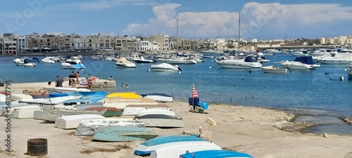 Boats on the beach and a beautiful view of the sea  with blue sky and  houses