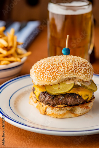 Hamburger. Bacon Cheeseburger. Classic traditional American bar, restaurant entree. Beef hamburger with Swiss and cheddar cheeses served with lettuce, tomato, onion and hand cut french fries. 