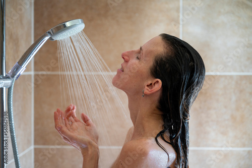 Profile view of a young woman taking a shower