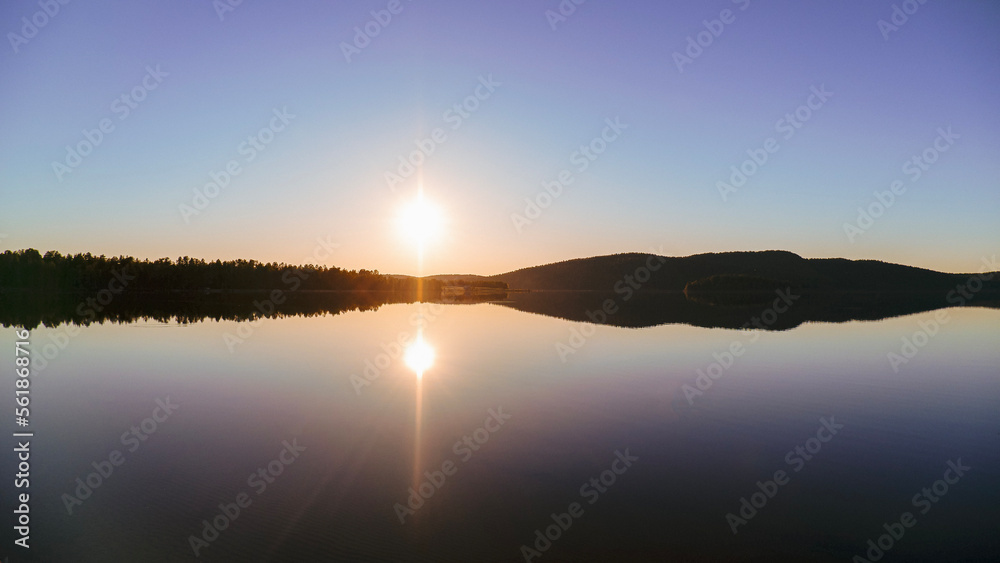 midnight sun over a calm lake