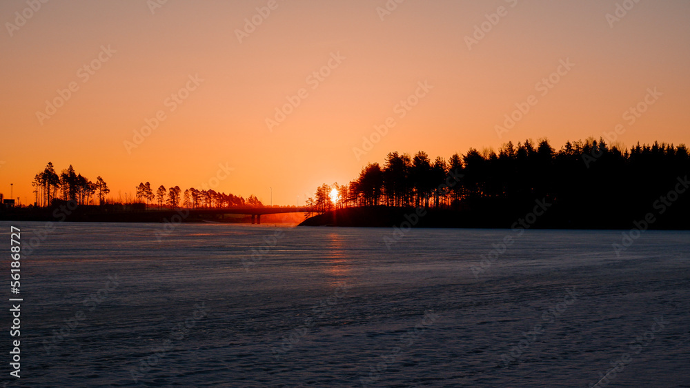 sunrise over a frozen lake
