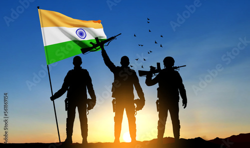 Silhouettes of soldiers with India flag on a background the sunset. Concept - Indian Army. EPS10 vector