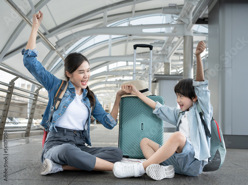 Travel Advertisement. Portrait Of Happy Asian mother Walking With Luggage At Airport, Beautiful Asia Mother, Father And Little Son Going To Boarding, Enjoying Traveling Together photo