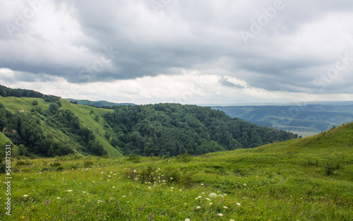 panorama of green hills and valleys in a hazy haze on the horizon in Kislovodsk on a cloudy summer day and space for copying