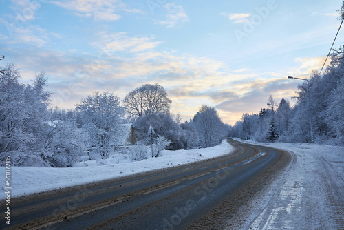 trees covered with snow on a frosty day winter road. © justoomm