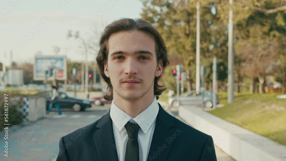 Happy White man with brown hair is walking in the city on the summer. Young smiling businessman walks in the city. Young stylish man in business suit is walking on the street. Happy White man with brown hair is walking in the city on the summer. Young smiling businessman walks in the city. Young stylish man in business suit is walking on the street.