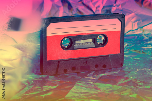 old cassette tape on crumpled neon background. retro and nostalgia style. vintage music concept. Y2K design trend, 2000 year