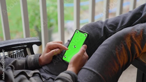Person scrolling on iphone green screen