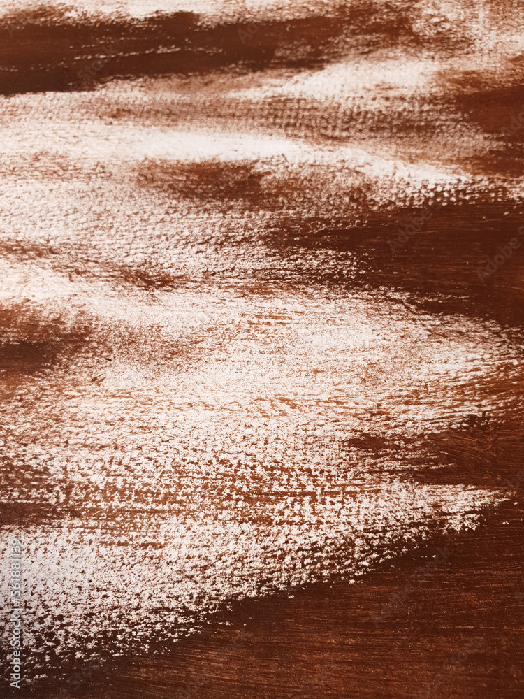 Artistic background with acrylic or gouache brown paint on textured canvas paper. Brushstrokes of brown paint. Vertical perspective abstract backdrop with copy space. Selective focus, close up.