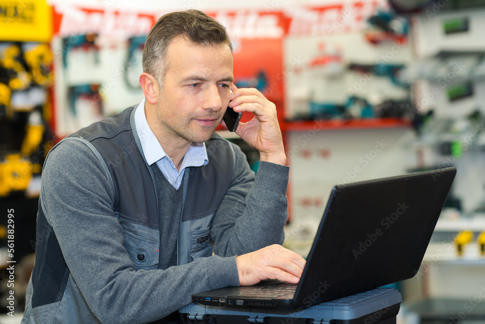 © auremar - businessman with a laptop in store