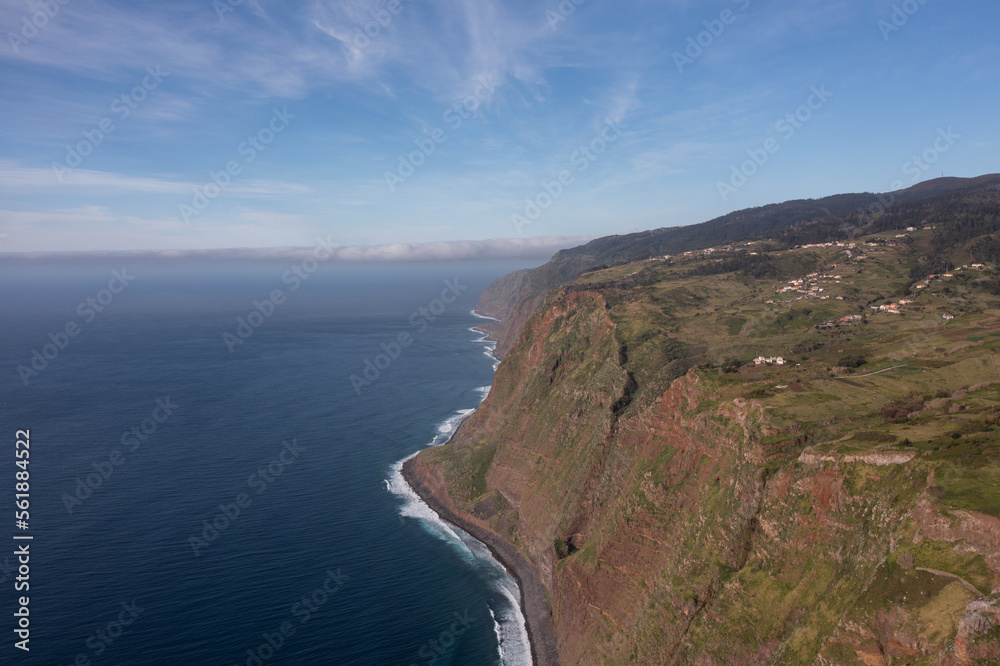 Great drone photo of a small village in Madeira built on huge cliffs.