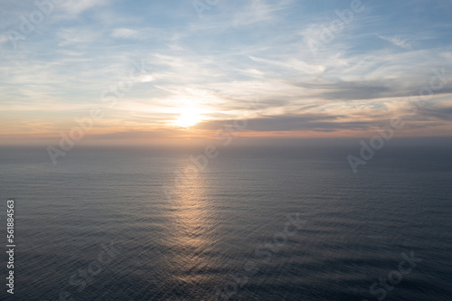 Great drone photo of a sunset over the Atlantic Ocean with a bit of cloud cover.