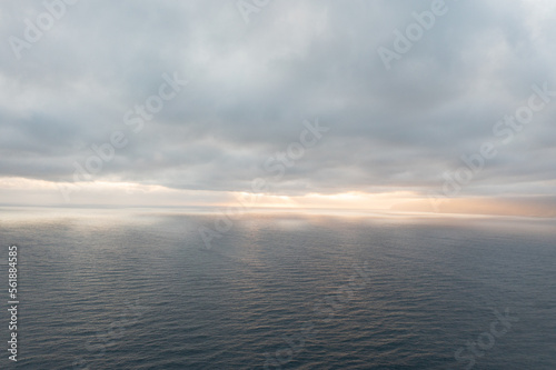 Great drone photo of a sunset over the Atlantic Ocean with a bit of cloud cover. © Philip