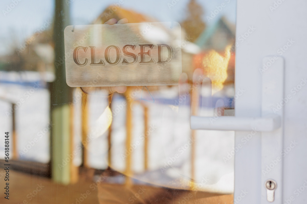 wooden sign with inscription closed at glass entrance door. working hours of the restaurant or office. welcome we are opening. cozy cafeteria or coworking wooden sign with inscription closed at glass entrance door. working hours of the restaurant or office. welcome we are opening. cozy cafeteria or coworking