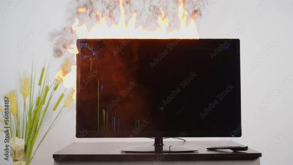 Burning TV on table in room. Faulty television burns indoors