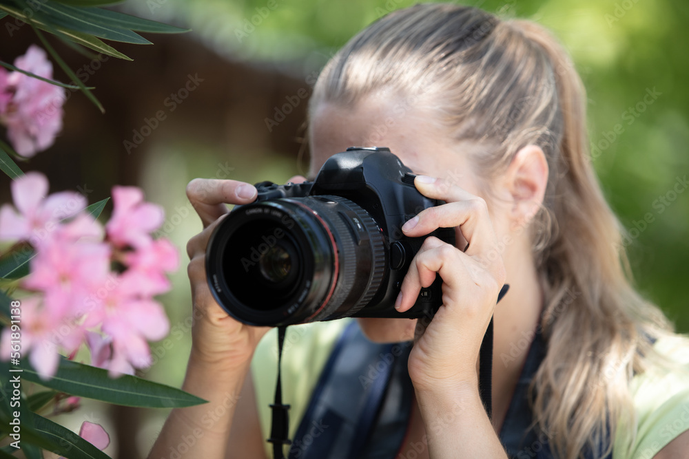 beautiful woman taking photographs of tulips in a spring garden beautiful woman taking photographs of tulips in a spring garden