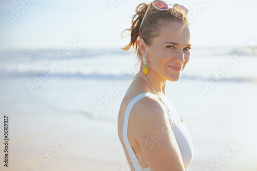 Portrait of smiling woman in beachwear at beach relaxing