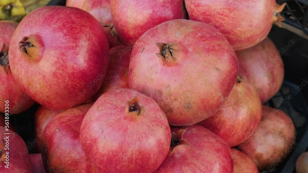 Fresh ripe pomegranate fruits on the food market. Organic food. Shopping concept. 4k video Fresh ripe pomegranate fruits on the food market. Organic food. Shopping concept. 4k video