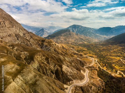 Winding road in the Dagestan Mountains with big mountain formation in the background. Russia