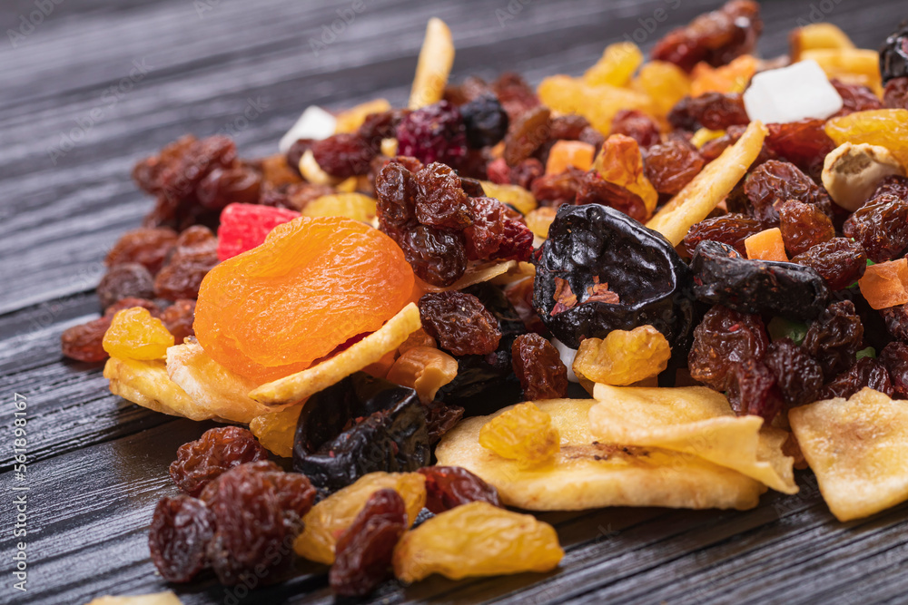 wooden background in retro style. a mixture of dried fruits lies on it. close-up. there is a tinting. soft focus. wooden background in retro style. a mixture of dried fruits lies on it. close-up. there is a tinting. soft focus.
