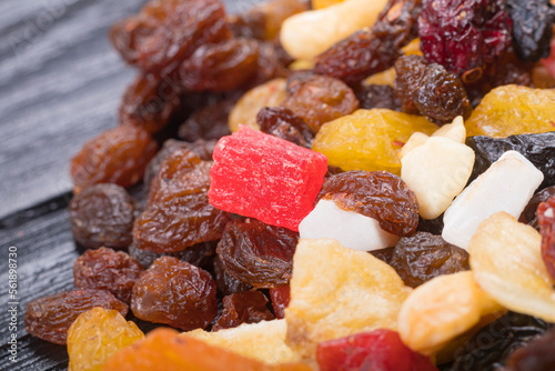 Fototapeta Naklejka Na Ścianę i Meble -  wooden background in retro style. a mixture of dried fruits lies on it. close-up. there is a tinting. soft focus.