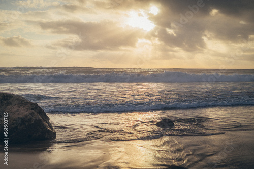 sunset on the beach. sea waves hitting the rocks on the beach. incredible view and relaxation on the beach.