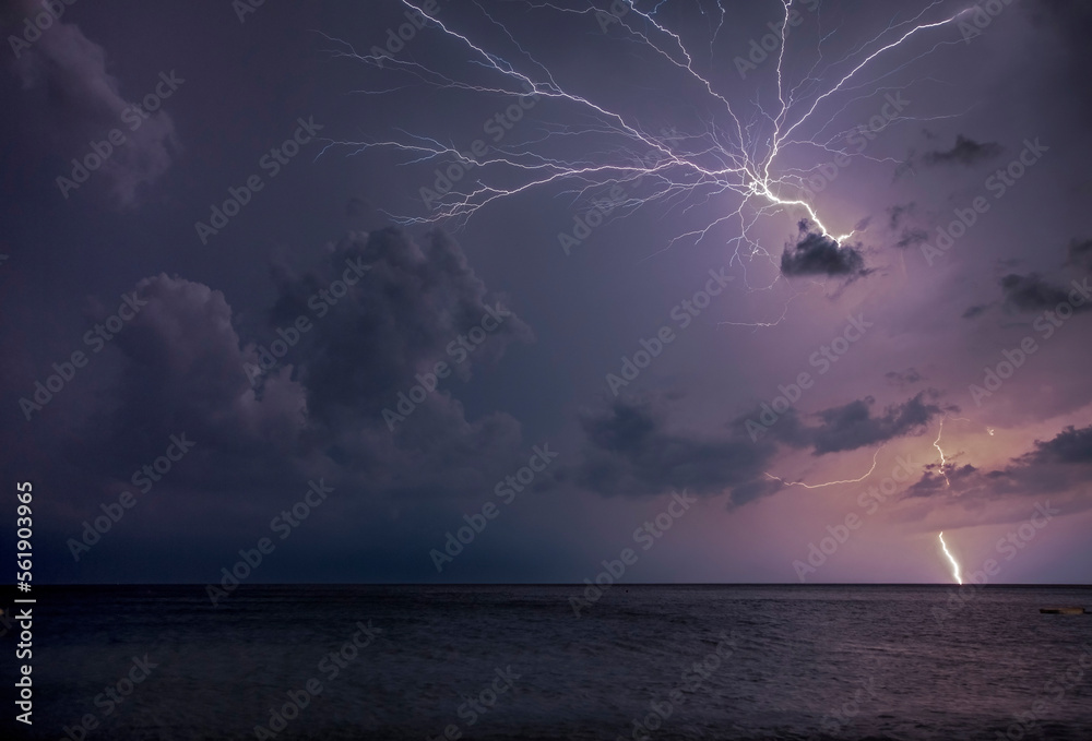 A flash breaks the sky on a turbulent night in the Ligurian coast