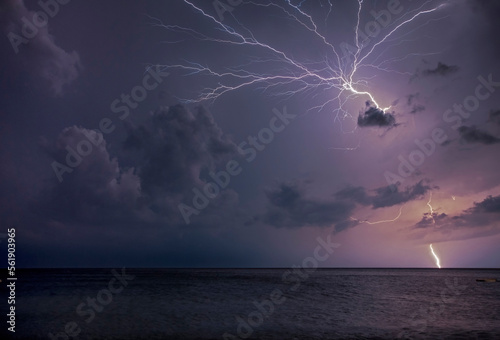 Obraz na płótnie A flash breaks the sky on a turbulent night in the Ligurian coast w salonie