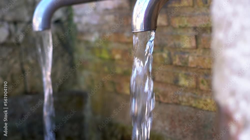 Slow motion, water flowing from a faucet