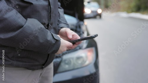 Car broken down by roadside with hazard lights and hood open, man on cellphone calling for help, tow truck. 4K 24FPS