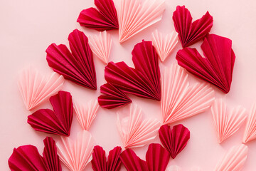 Happy Valentine's day ! Stylish pink and red hearts flat lay on pink paper background. Creative modern valentines hearts cutouts composition. Love background