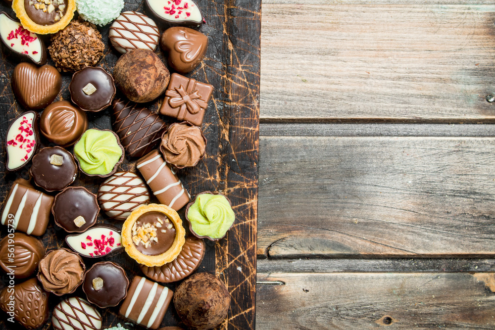 Chocolate sweets on a wooden Board. Chocolate sweets on a wooden Board.