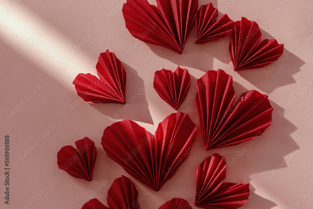 Obraz premium Valentines day flat lay. Stylish red hearts composition on pink paper background in sunlight. Happy Valentine's day! Modern cute valentine heart cutouts. Creative love banner