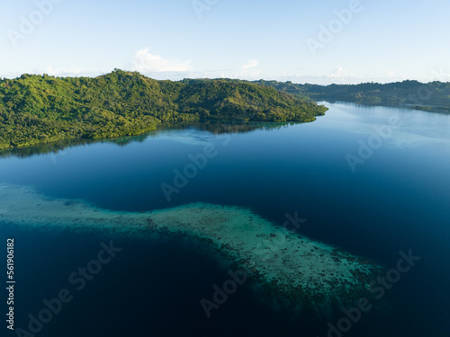 A coral reef fringes a lush, tropical islands found in a remote part of the Solomon Islands. This beautiful Melanesian island nation harbors extraordinary marine and terrestrial biodiversity.