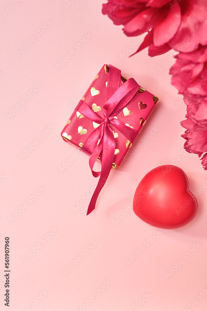 Flat lay valentines day frame with red peonies and red hearts, gift box on a pink background. Valentines day banner with copy space Flat lay valentines day frame with red peonies and red hearts, gift box on a pink background. Valentines day banner with copy space