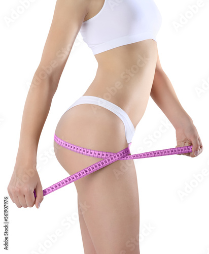 Female body, young slim woman in underwear measures the circumference of thigh with a tape measure, isolated on a transparent background, concept of body care, healthy diet and cellulite treatment.