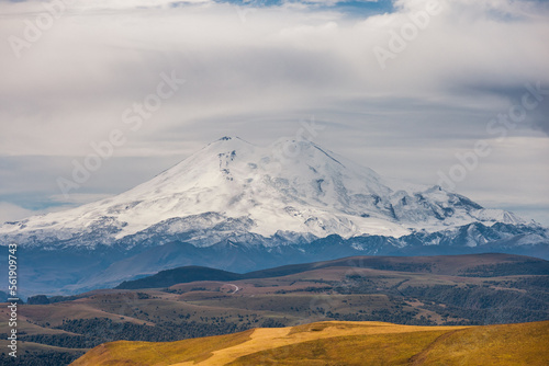 Big mountain Elbrus against the blue sky. View from a large plateau and steep cliffs. © Aleksei Zakharov