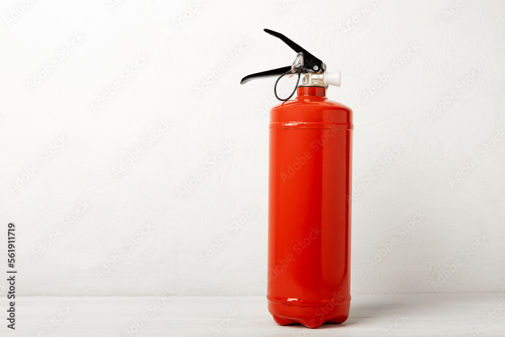 Fire extinguisher on a white texture background. Fire protection, home fire extinguisher. home security concept. Place for text. Copy space. Fire extinguisher on a white texture background. Fire protection, home fire extinguisher. home security concept. Place for text. Copy space.
