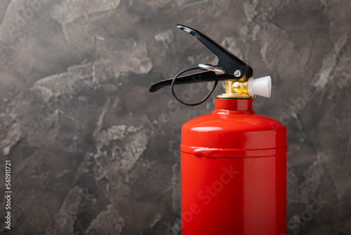 Fire extinguisher on a black marble background. Fire protection, home fire extinguisher. home security concept. Place for text. Copy space.