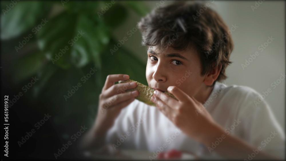 Candid boy eating healthy melon fruit dessert Candid boy eating healthy melon fruit dessert