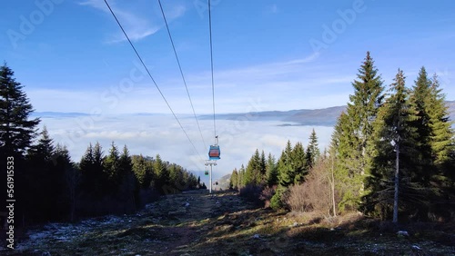 Cable car going up from the city of Sarajevo Capital of Bosnia and Herzegovina to Trebevic mountain. City below the clouds. Amazing travel destination. Tourism and vacations in the mountains. 